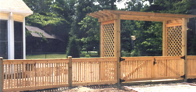 Wood pergola with spaced good neighbor fence by Elyria Fence